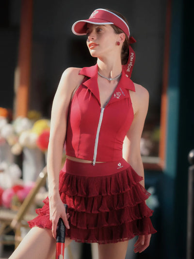 Woman wearing a red outfit with a matching visor in an outdoor setting