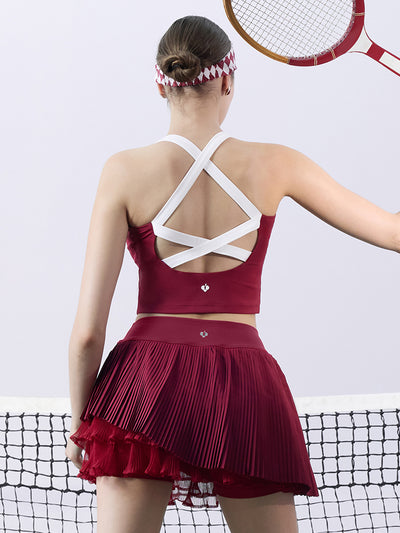 Red cropped tank top with contrast trim, bow detail, and printed logo for a sleek, sporty look.