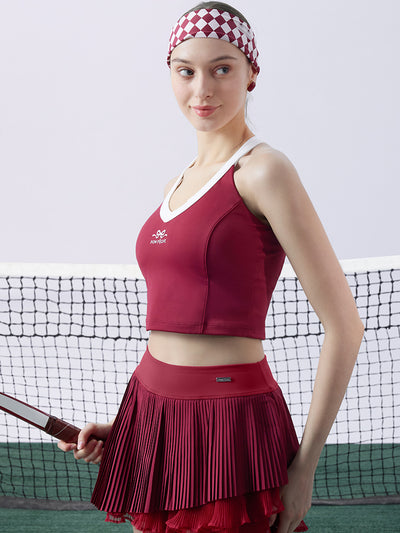 Red cropped tank top with contrast trim, bow detail, and printed logo for a sleek, sporty look.