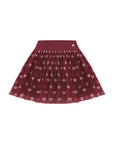 This product shot shows a women’s mesh tennis skirt with a red heart pattern designed for tennis performance