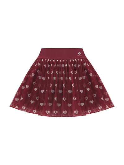 This product shot shows a women’s mesh tennis skirt with a red heart pattern designed for tennis performance