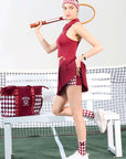 Side view of red asymmetrical pleated tennis skirt paired with athletic top, showing dynamic court style and high-waisted tennis skirt design.