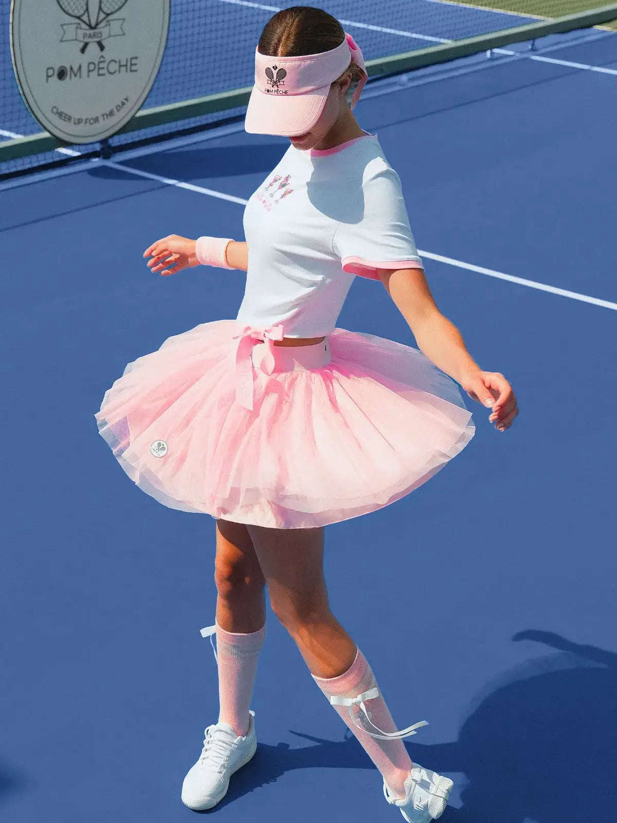 Women on the tennis court wearing Tulle Puff Tennis Skirt