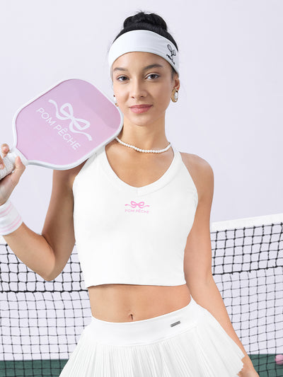 White cropped tank top with contrast trim, bow detail, and printed logo for a sleek, sporty look.