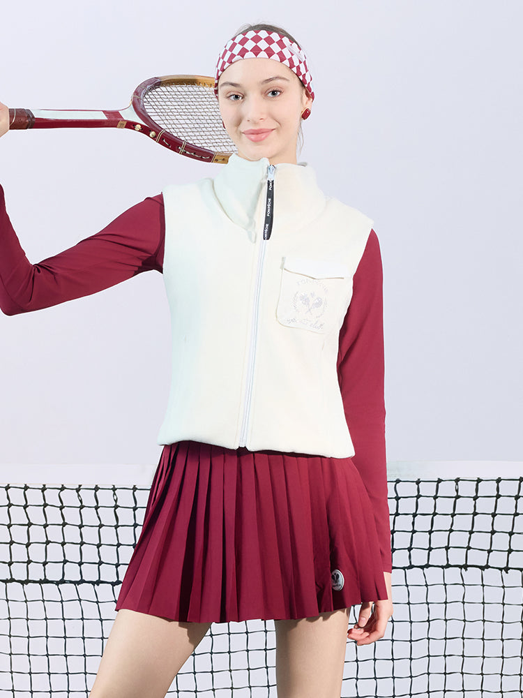 Warm white fleece vest with high-neck zip design and embroidered chest pocket, styled on the tennis court.