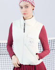 Warm white fleece vest with high-neck zip design and embroidered chest pocket, styled on the tennis court.