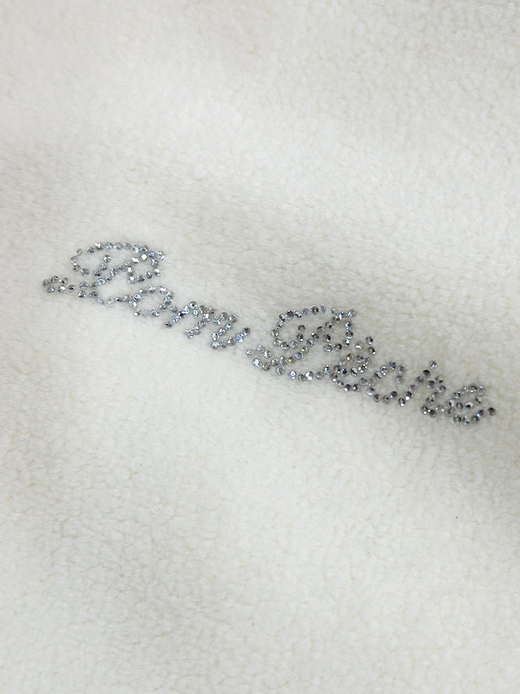 Warm white fleece vest with high-neck zip design and embroidered chest pocket, styled on the tennis court.