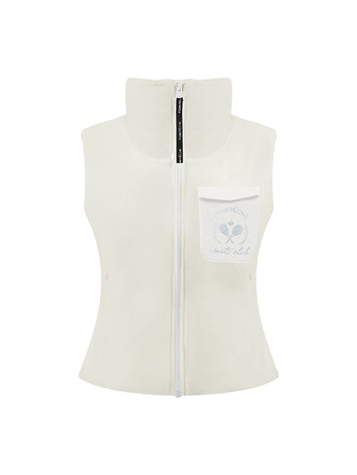 Warm white fleece vest with high-neck zip design and embroidered chest pocket, styled on the tennis court.