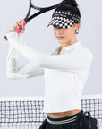 White long-sleeve zip-collar polo top with a subtle printed logo, featuring a fitted silhouette for a sleek, sporty look.