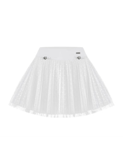 White pleated tennis skirt with soft mesh lace and subtle heart details, offering a lightweight feel, styled on a tennis court. 