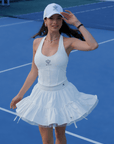 White ruffle tennis skirt with bow details, a soft layered look and airy movement.