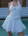 White ruffle tennis skirt with bow details, a soft layered look and airy movement.