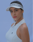 White tennis visor with a Pom Pêche logo on the band.