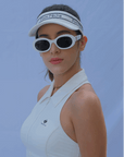 
White tennis visor with a Pom Pêche logo on the band.