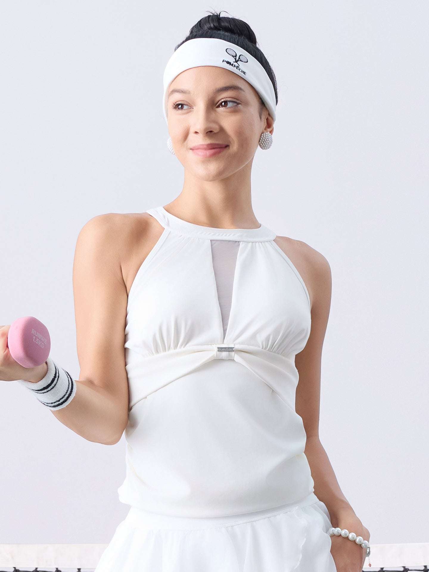 White mesh halter tennis top with a twist-front detail, offering a flattering fit and lightweight comfort for on-court wear.