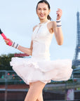 Detail of petal tiered tennis skirt – three airy chiffon layers with irregular hem for dynamic motion.