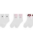 White ankle tennis socks with red bow detail and Pom Pêche logo, styled on the court.