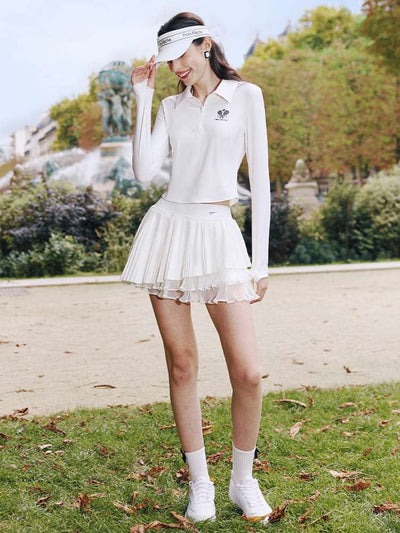 White pleated tennis skirt with layered mesh styled outdoors