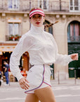 Model wearing White Poise UPF protection sun jacket outdoors, lightweight breathable women’s activewear
