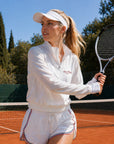 White Poise sun jacket worn on tennis court, women’s UPF50+ lightweight sporty jacket for outdoor performance