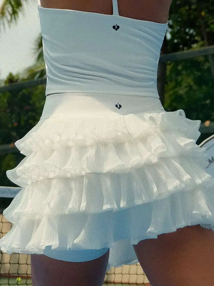White ruffled skirt worn by a person with a blurred background