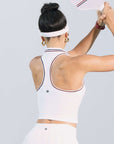 White zip-front tennis tank with red and blue contrast trims, perfect for court or city wear.