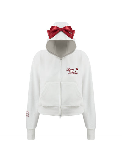 White zip-up hoodie with bow detail on the hood and embroidered logo, perfect for warm-ups or everyday wear.