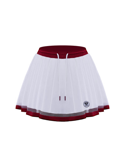 Studio shot of white wavy hem tennis skirt with red waistband and tie detail, highlighting crisp pleats and sporty tennis skirt styling.