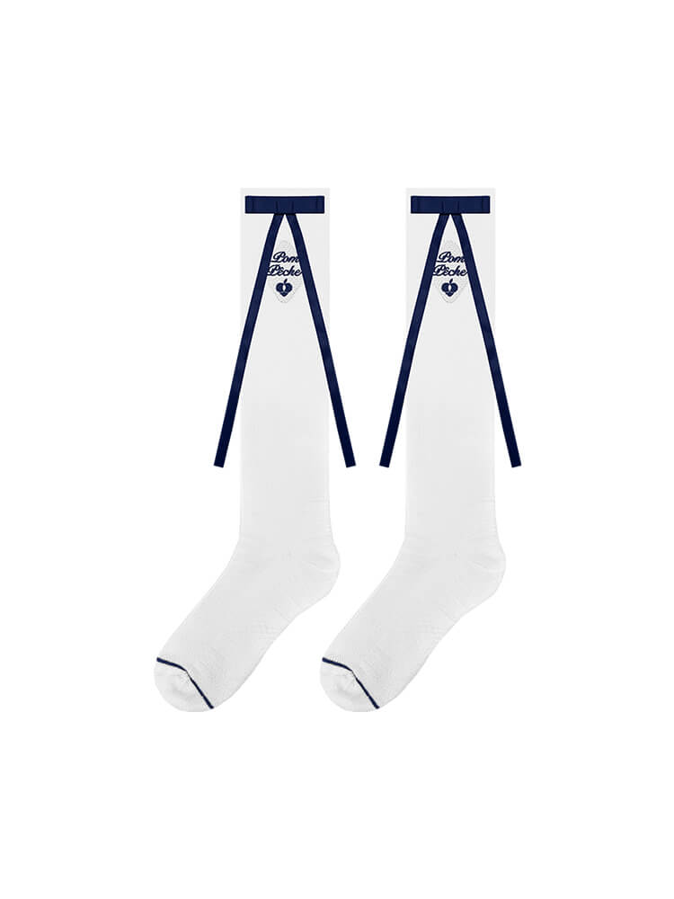 White knee-high tennis socks with blue bow detail and logo embroidery.