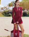 Deep red long-sleeve zip-collar polo top with a subtle printed logo, featuring a fitted silhouette for a sleek, sporty look.