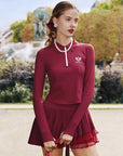 Deep red long-sleeve zip-collar polo top with a subtle printed logo, featuring a fitted silhouette for a sleek, sporty look.