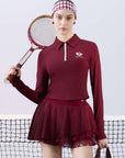 Deep red long-sleeve zip-collar polo top with a subtle printed logo, featuring a fitted silhouette for a sleek, sporty look.