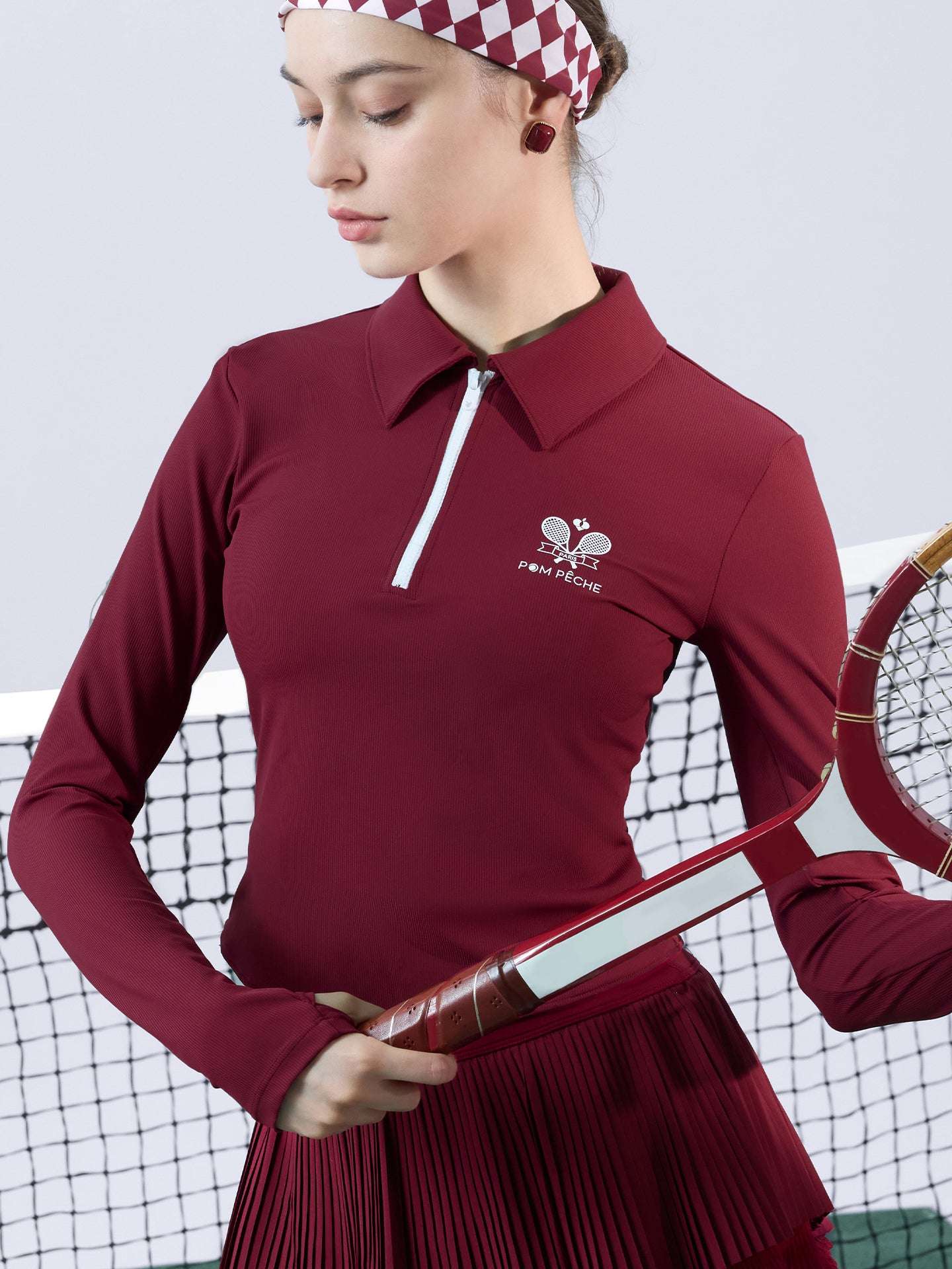 Deep red long-sleeve zip-collar polo top with a subtle printed logo, featuring a fitted silhouette for a sleek, sporty look.