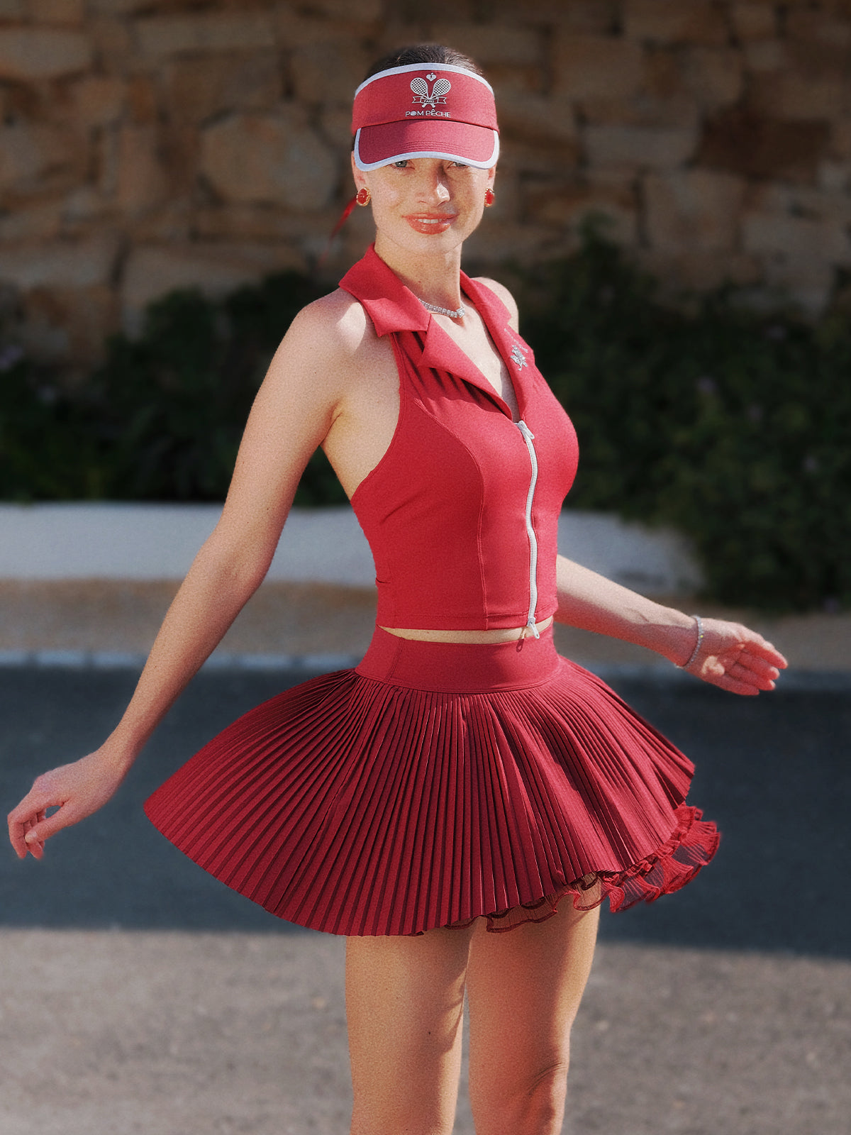 Wine red multi-layer asymmetric pleated skirt, side view highlighting fluid movement and lightweight 4-way stretch fabric.