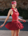 Wine red multi-layer asymmetric pleated skirt, side view highlighting fluid movement and lightweight 4-way stretch fabric.
