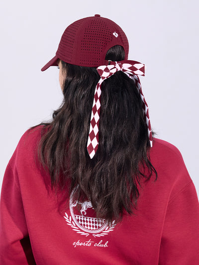 Wine red tennis cap with embroidered logo and adjustable ribbon on the back strap.
