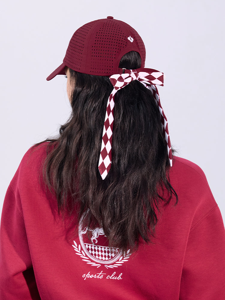 Wine red tennis cap with embroidered logo and adjustable ribbon on the back strap.