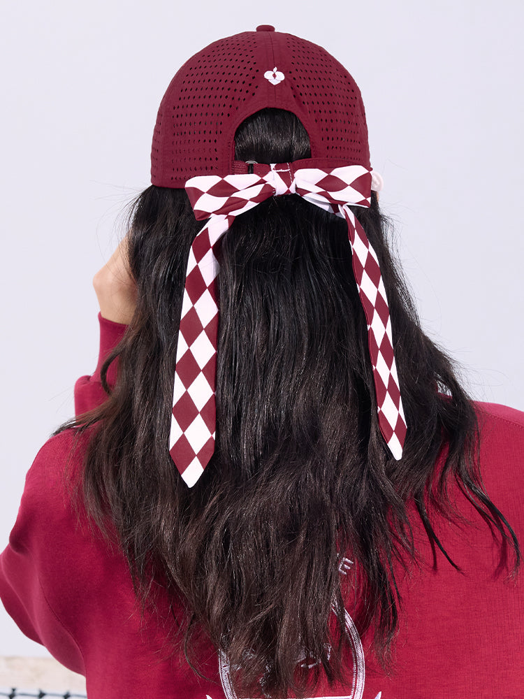 Wine red tennis cap with embroidered logo and adjustable ribbon on the back strap.