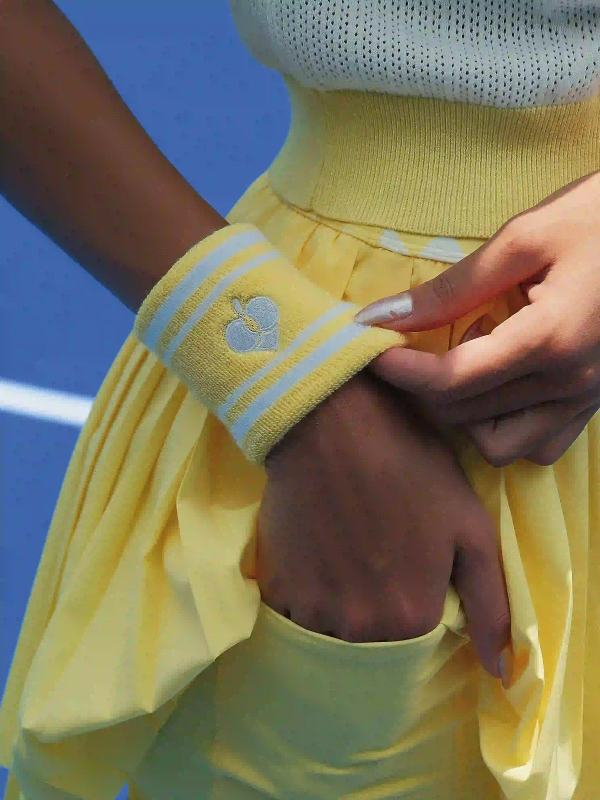 Person wearing a yellow outfit with a blue background