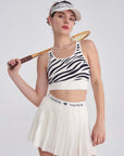White sports bra with printed zebra pattern, designed for comfort and style during active sports.