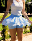 Betty Boop Cake Skirt Paris Blue spinning motion, showcasing layered ruffle cake skirt design, flowy polka dot mesh, and built-in shorts for confident movement