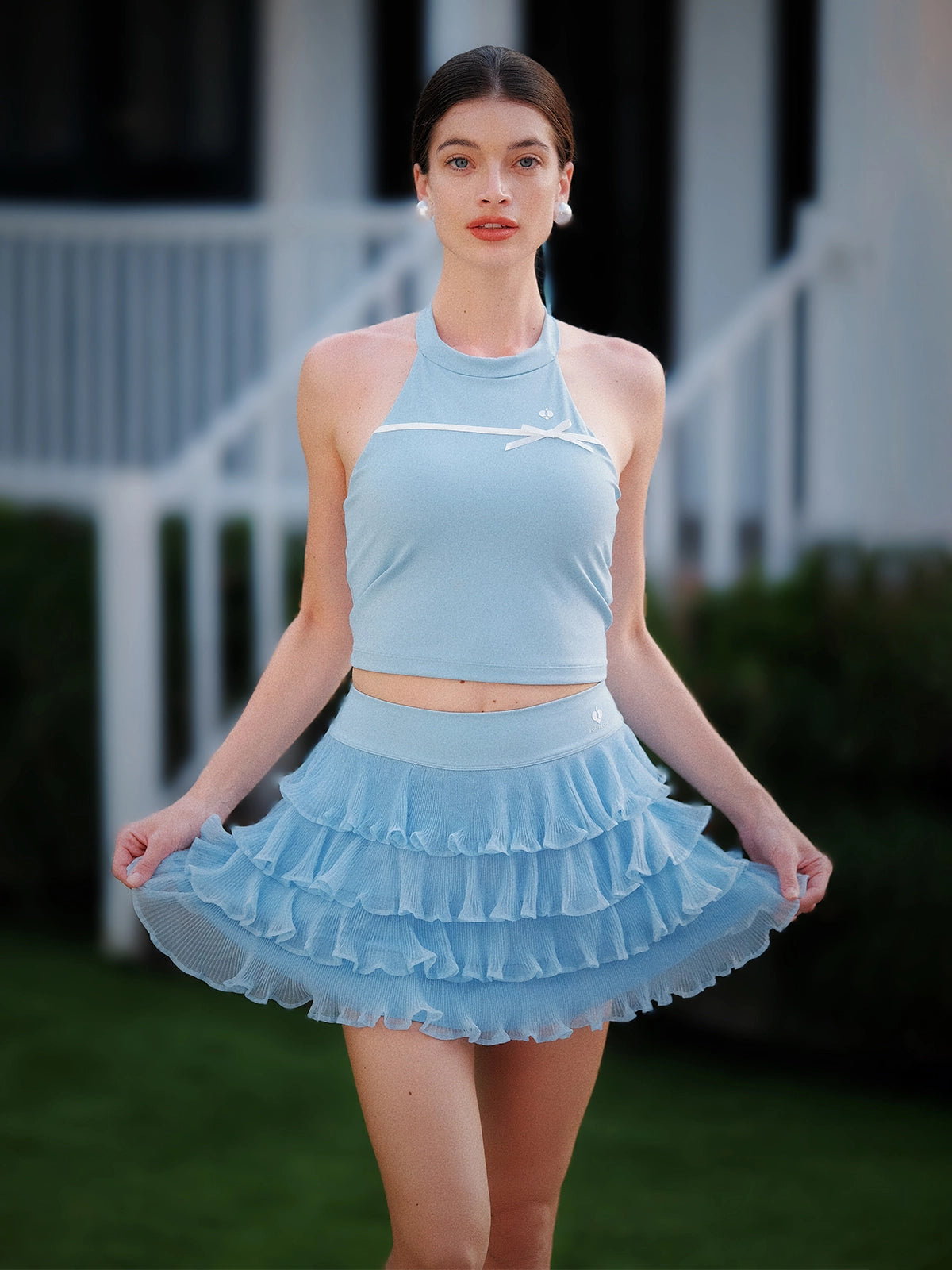 Blue Bow Halter Tennis Top worn with matching blue ruffle tennis skirt, Pom Pêche court-to-street full outfit