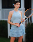 Blue Bow Halter Tennis Top with vintage tennis racket, blue ruffle skirt, outdoor sport editorial look by Pom Pêche