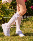 Side view of knee-high socks with detachable bow and non-slip stay-up design