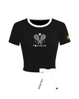 Contrast Trim Tennis Tee black flat lay – white contrast collar and cuff trim, Pom Pêche Paris crest logo, tennis ball sleeve badge, removable white ribbon bow