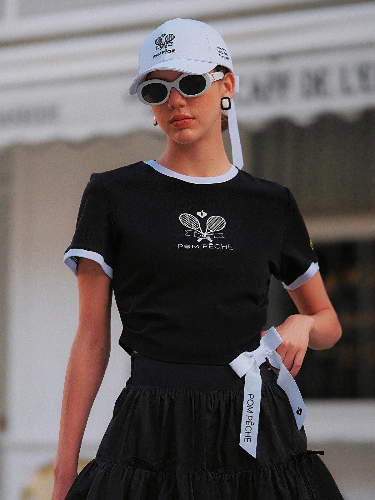 Contrast Trim Tennis Tee in black by Pom Pêche, front view with white contrast collar and cuff trim, Paris racquet crest print, slim-fit cotton tee