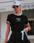 Contrast Trim Tennis Tee in black by Pom Pêche, front view with white contrast collar and cuff trim, Paris racquet crest print, slim-fit cotton tee