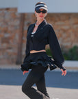 Side view of cropped UV tennis jacket with dual zipper waist cinch design, women’s fitted sporty jacket