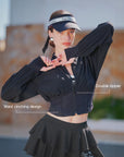 Cropped UV tennis jacket in black with dual zipper and waist cinch design, women’s fitted sporty jacket front view