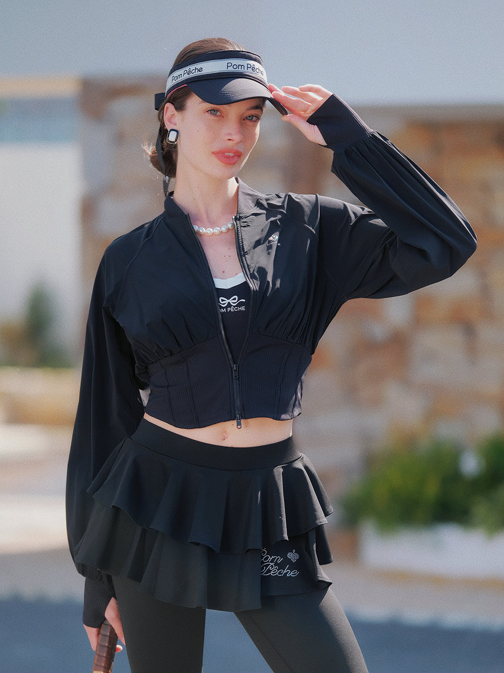 Cropped UV tennis jacket with waist cinch in black, women’s lightweight sporty jacket front view